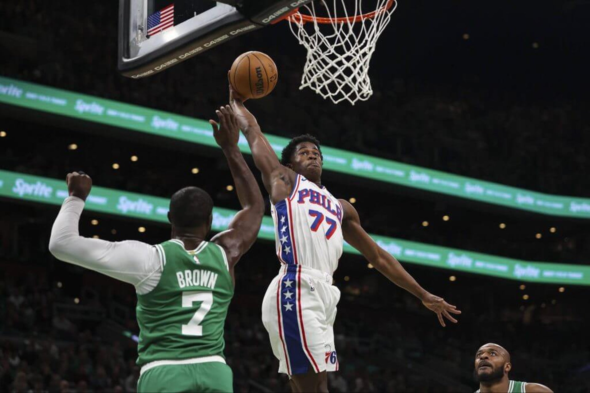 Sixers' V.J. Edgecombe dunks over the Celtics' Jaylen Brown in the first quarter on Wednesday.