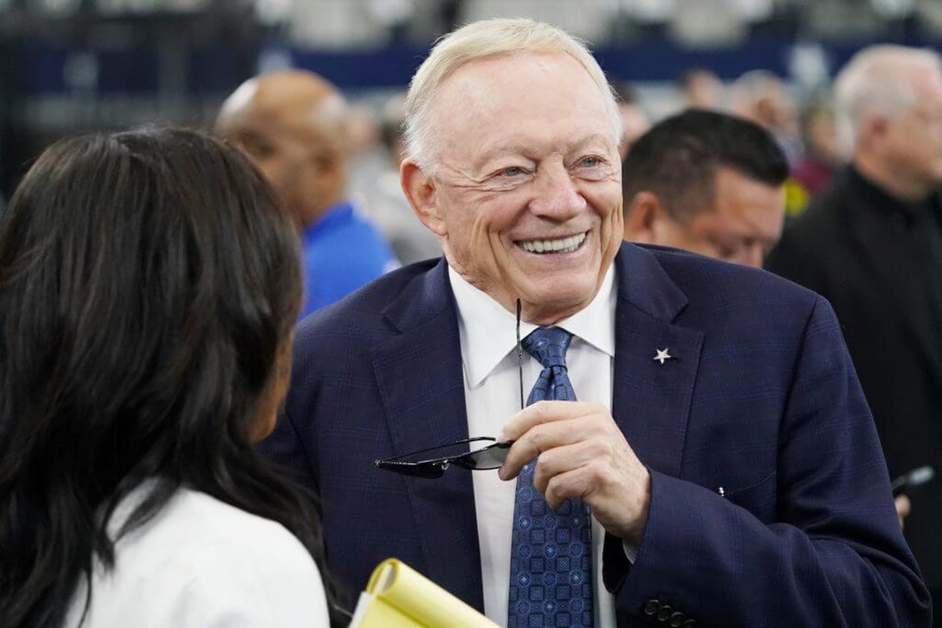 Cowboys owner Jerry Jones speaks with a reporter while holding his glasses on the field before Dallas played the New York Giants at AT&T Stadium earlier this season.
