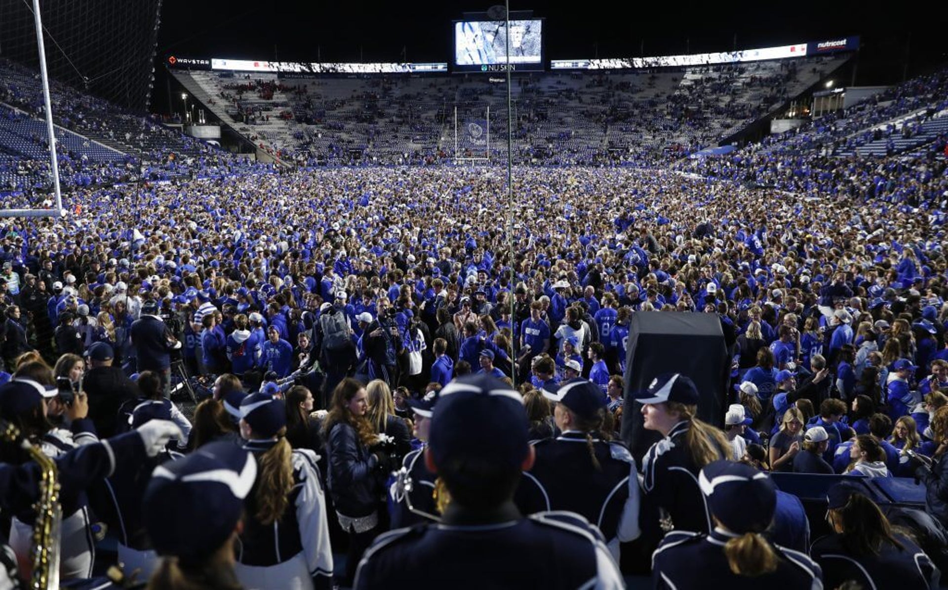 BYU fans storm field after the Cougars beat Utah