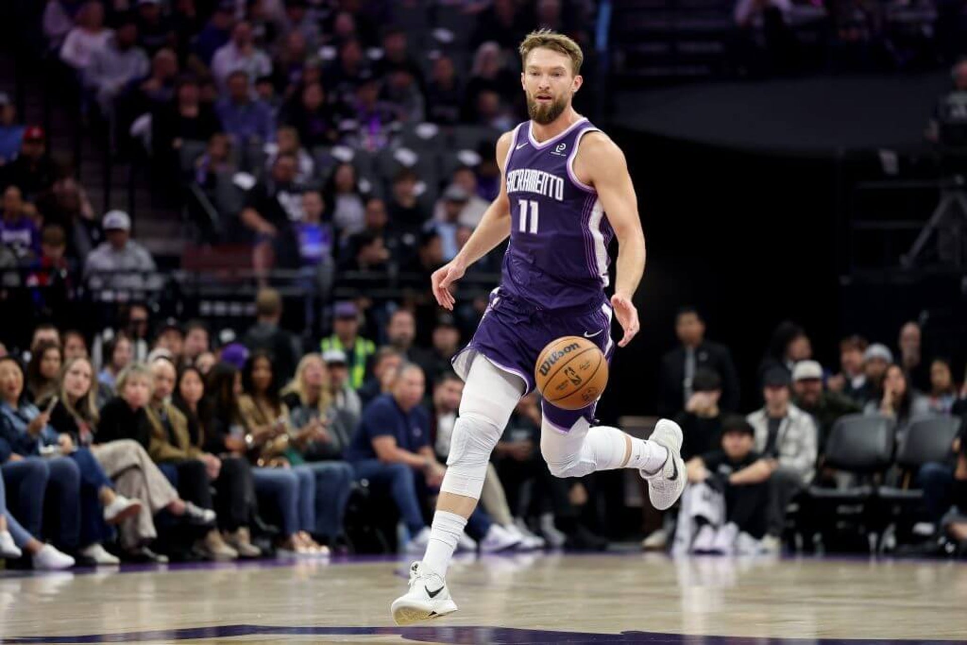 Domantas Sabonis (11) of the Sacramento Kings dribbles the ball against the Atlanta Hawks at Golden 1 Center.