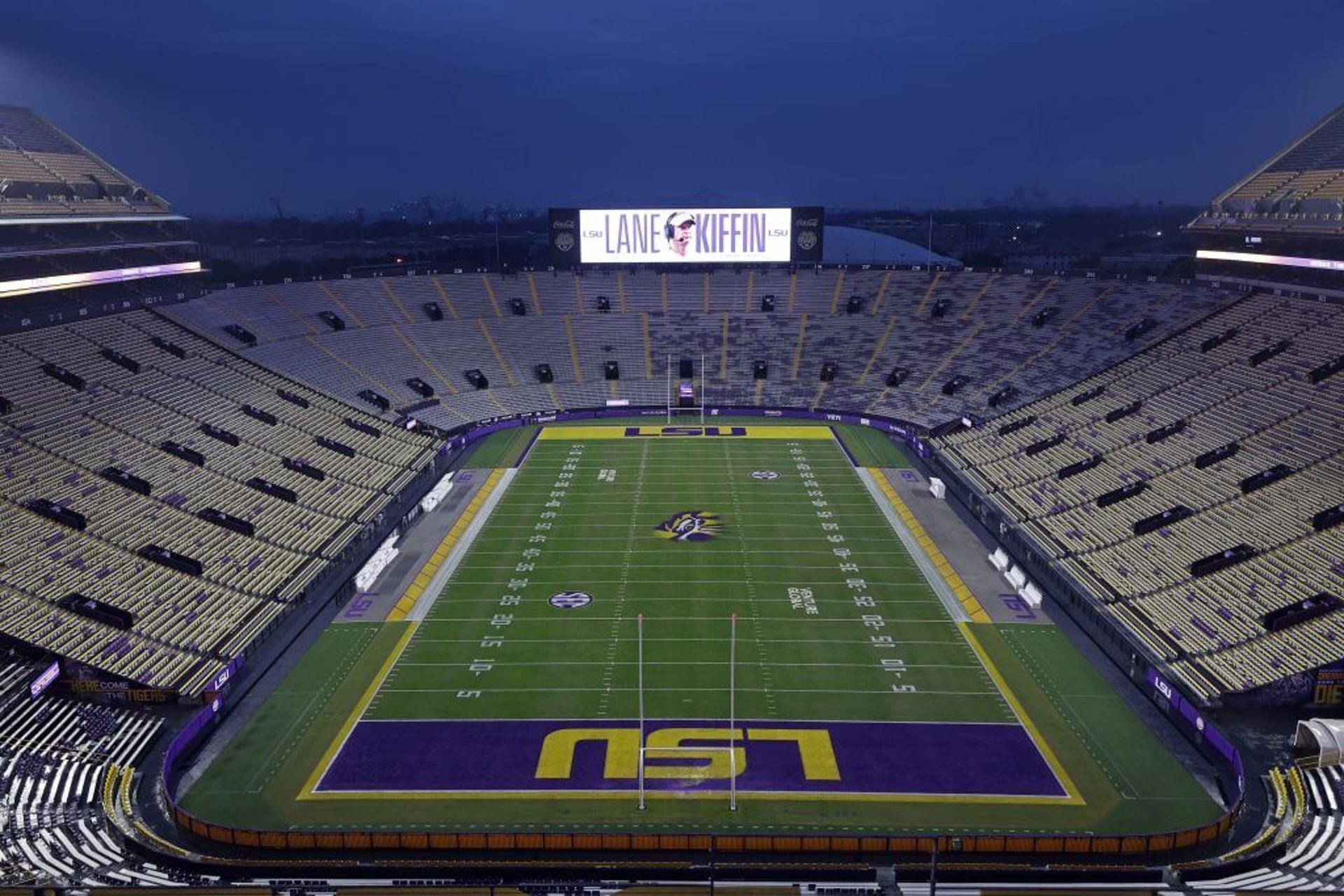 A photo of the inside of LSU's Tiger Stadium, with Lane Kiffin's name on the video board.