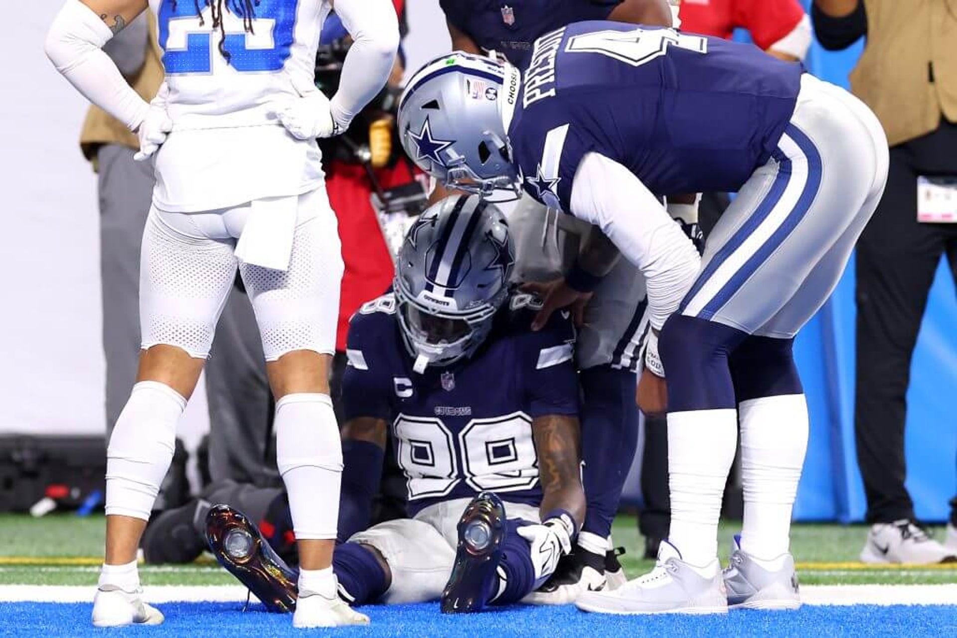 Cowboys QB Dak Prescott (right) checks on WR CeeDee Lamb (center) after he dropped a ball in the end zone against the Lions.