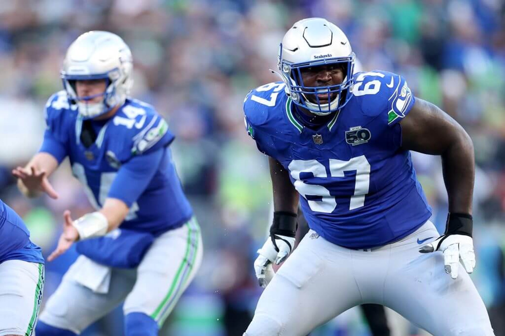 Seattle Seahawks left tackle Charles Cross gets out of his stance to block during an NFL game against the Minnesota Vikings.