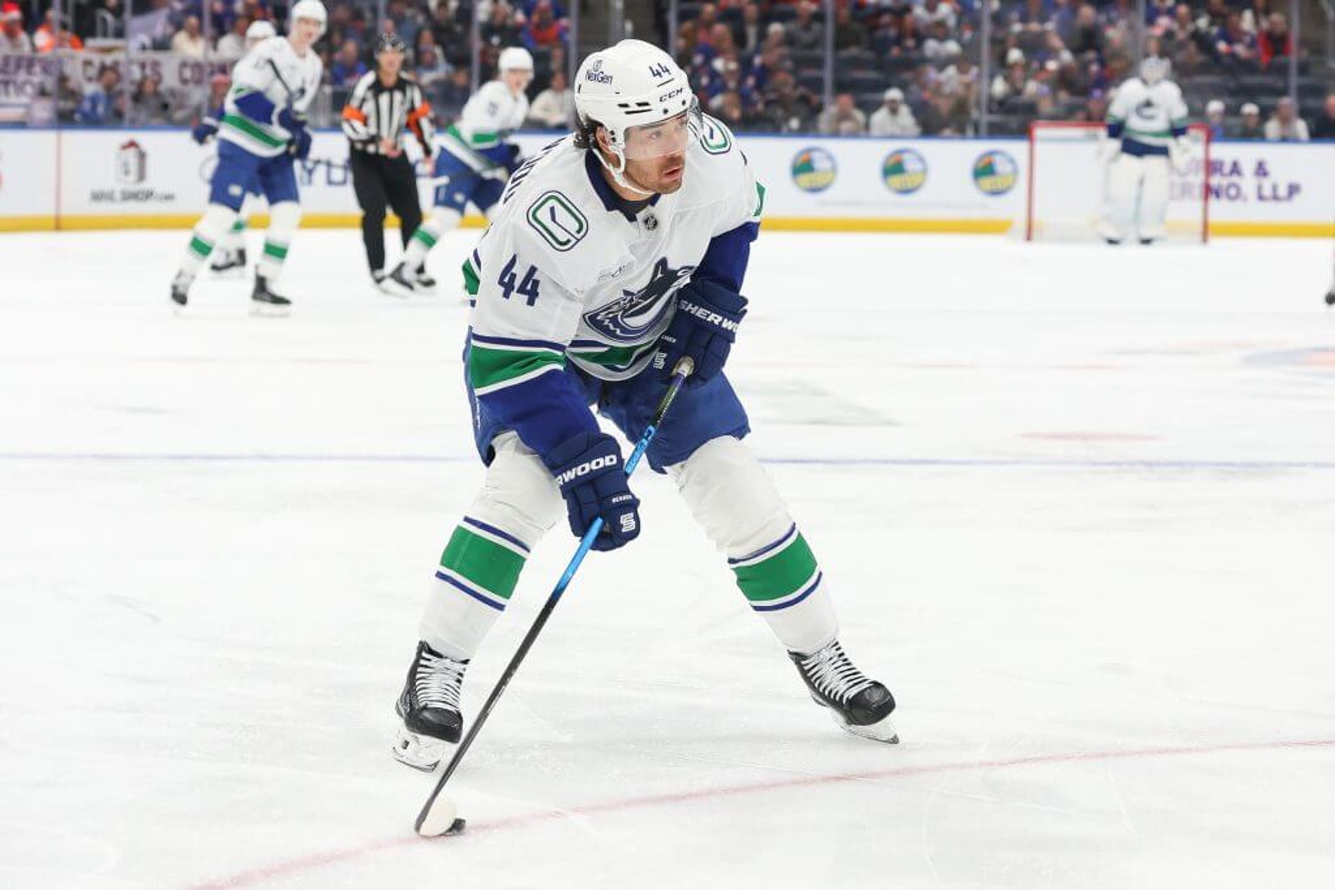 Kiefer Sherwood of the Vancouver Canucks skates with the puck during the first period of a game against the New York Islanders at UBS Arena on December 19, 2025.
