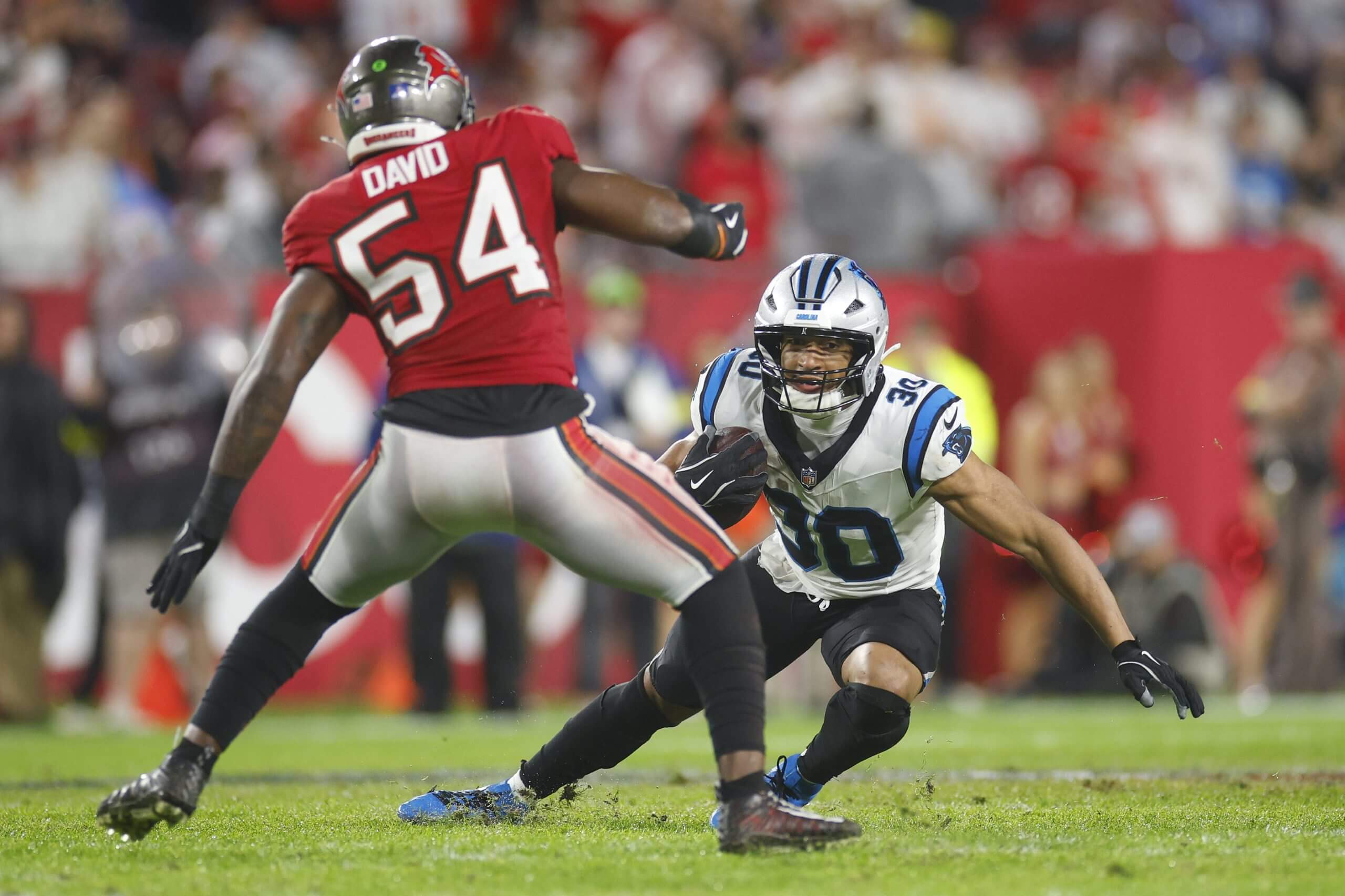 Chuba Hubbard #30 of the Carolina Panthers is tackled by Lavonte David #54 of the Tampa Bay Buccaneers during the third quarter during a game at Raymond James Stadium on January 03, 2026 in Tampa, Florida