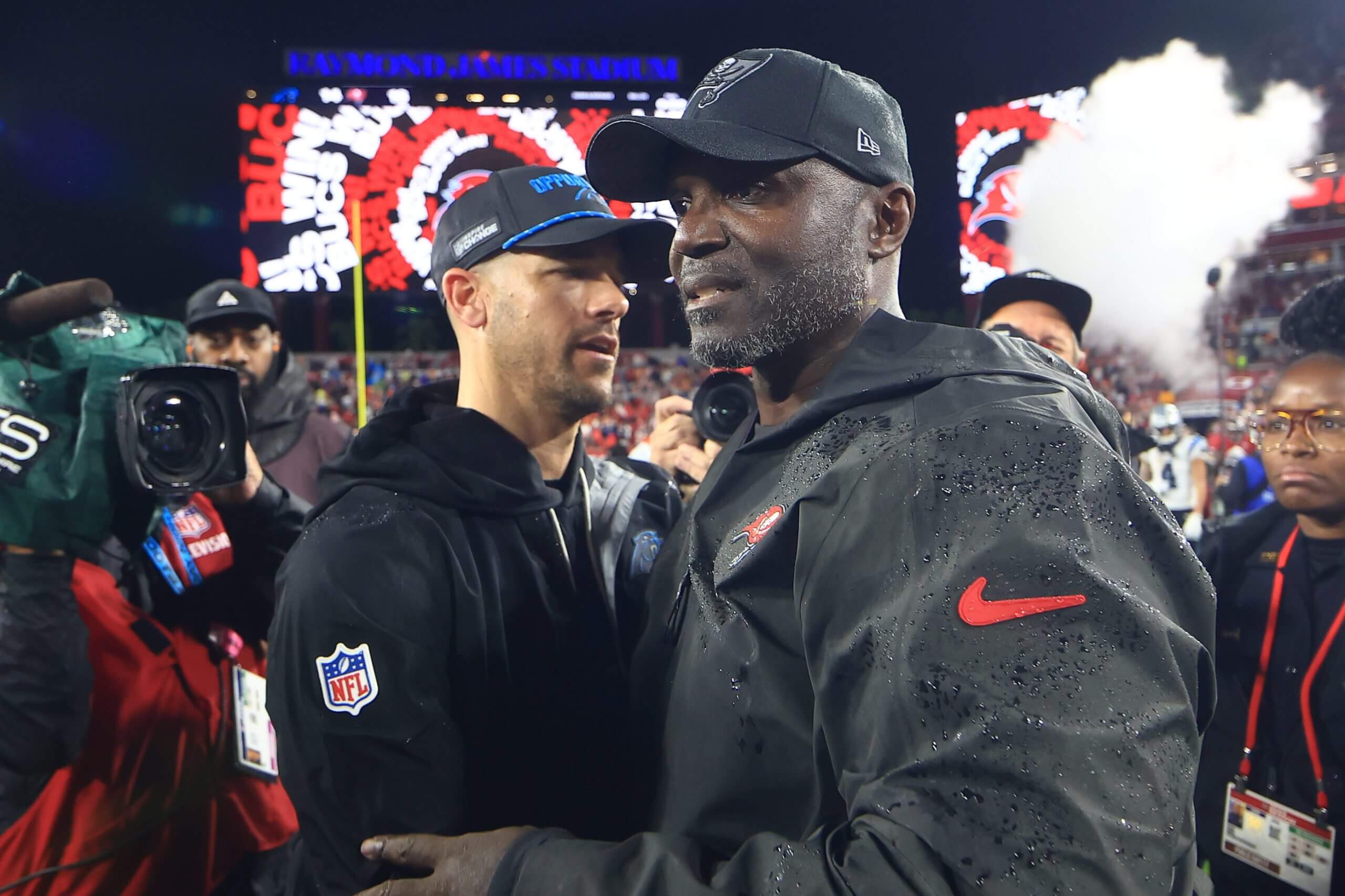 Head coach Dave Canales of the Carolina Panthers and head coach Todd Bowles of the Tampa Bay Buccaneers embrace after the game during a game at Raymond James Stadium.