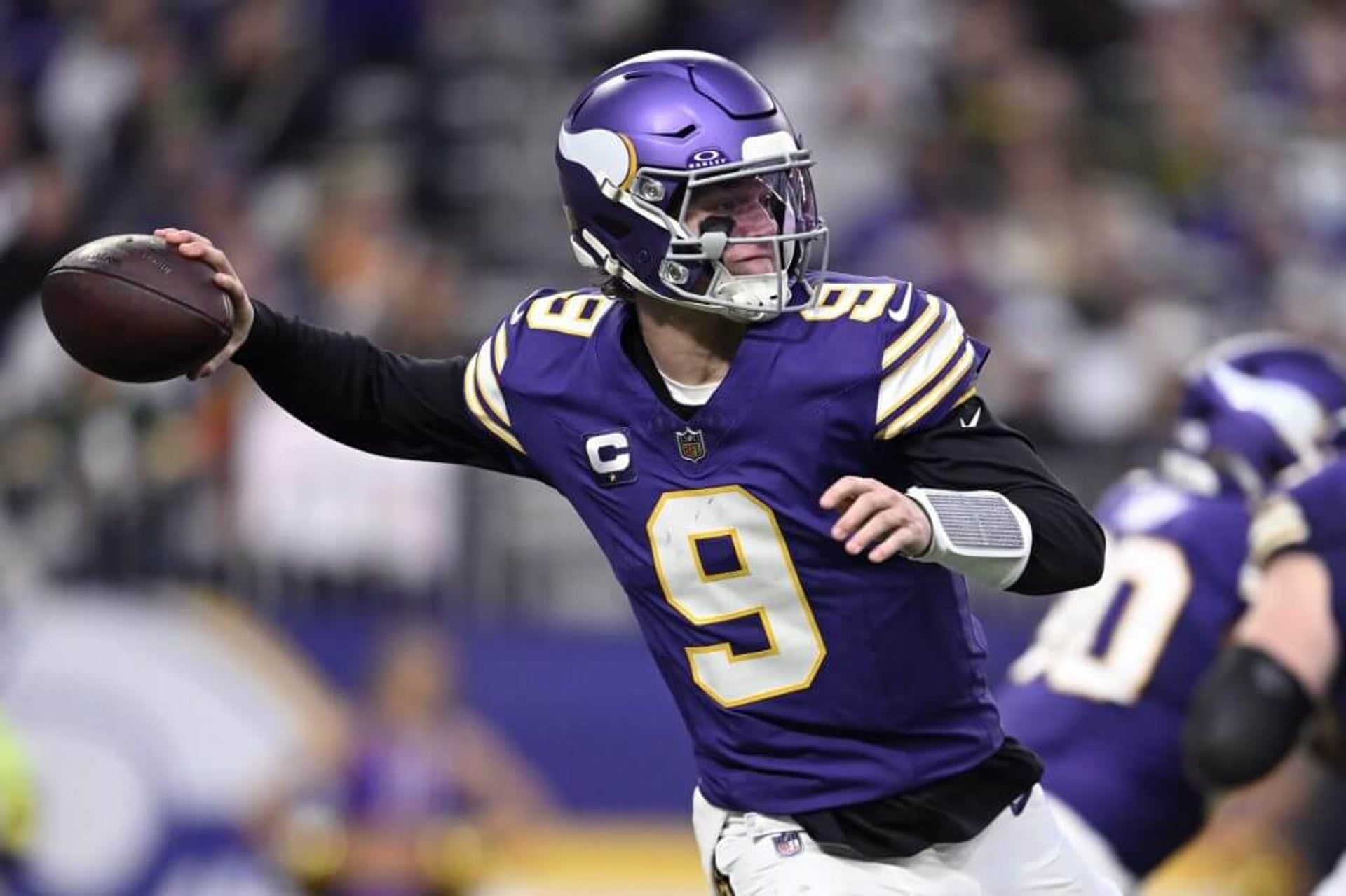 J.J. McCarthy #9 of the Minnesota Vikings throws a pass against the Green Bay Packers during the second quarter at U.S. Bank Stadium.