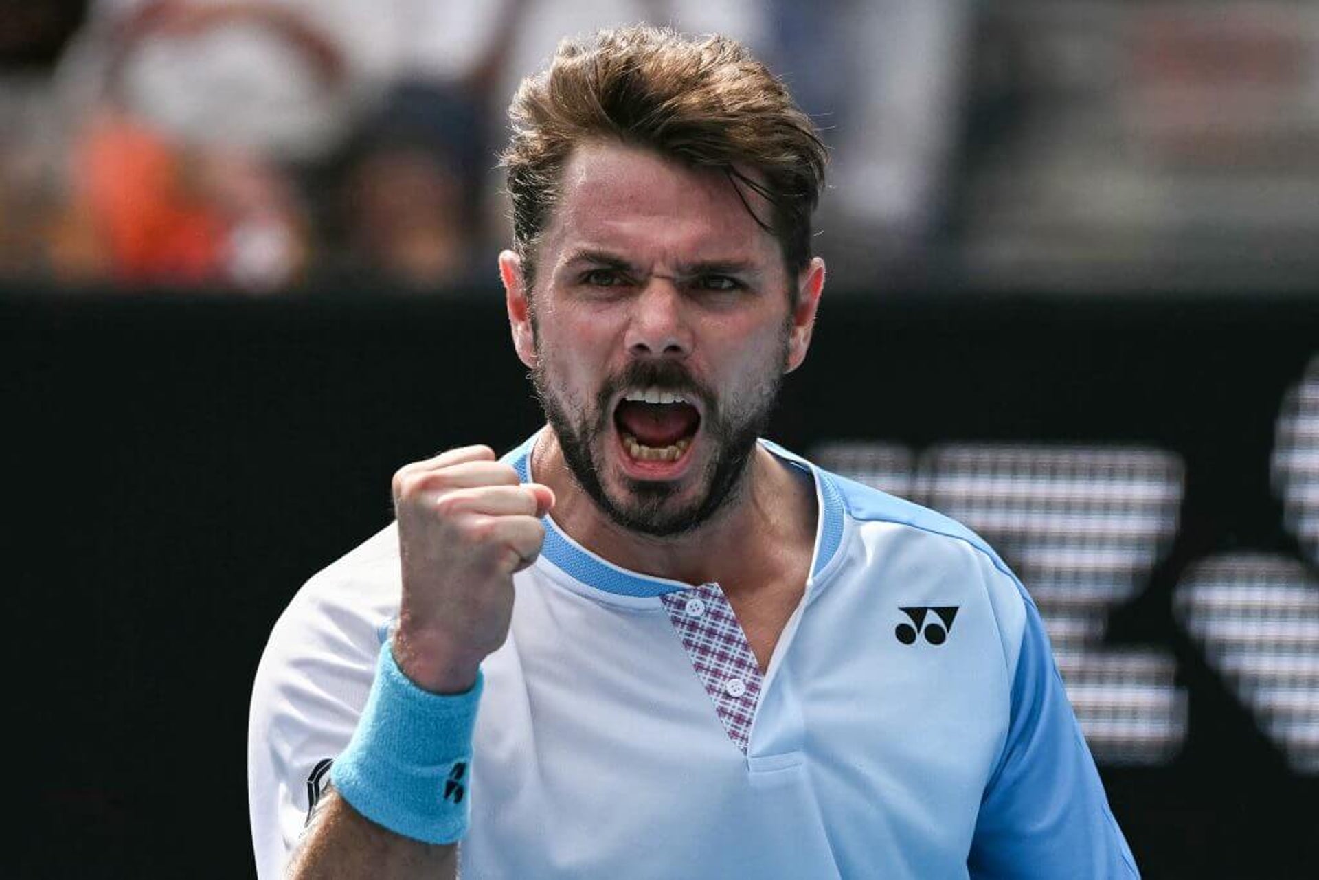 Stan Wawrinka pumps his fist and roars in celebration.